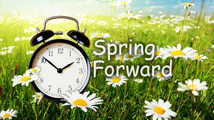 Field of flowers with a clock and the text Spring Forward.