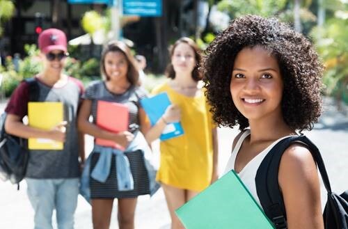 Girl smiling and holding a notebook